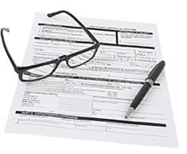 glasses and pen resting on form